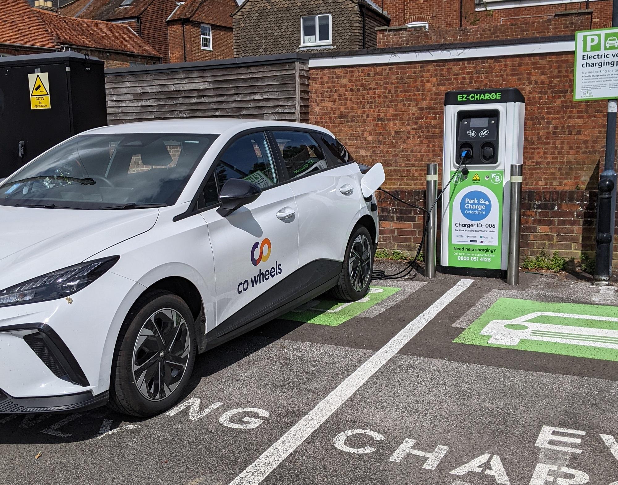 Co Wheels car parked at a charging station